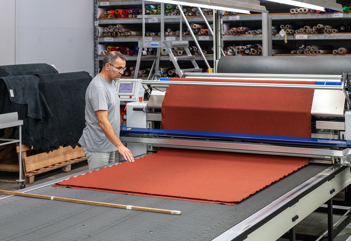Cutting the fabric for the new covers for the folding chairs in the riding arena